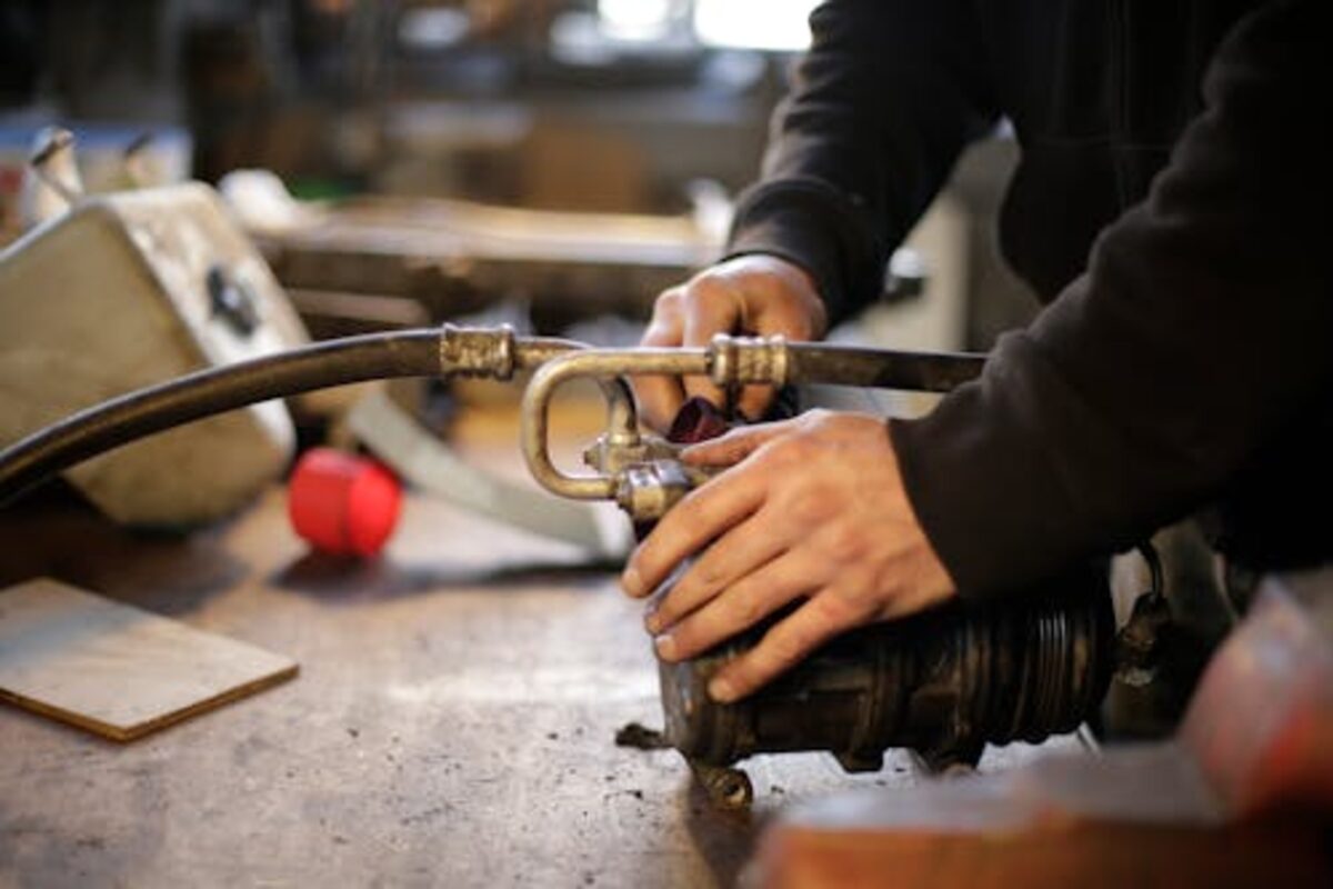 Hands building or repairing a wood workbench in a workshop